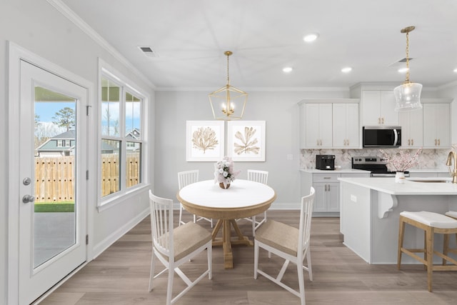 264 Prominence Dr, Grovetown, GA 30813 - dining room with crown molding, light wood-style floors, recessed lighting, a chandelier, and baseboards
