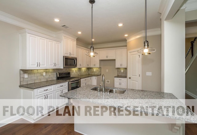 kitchen with visible vents, appliances with stainless steel finishes, pendant lighting, and a sink