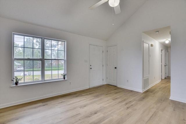 empty room with light hardwood / wood-style floors, high vaulted ceiling, and ceiling fan