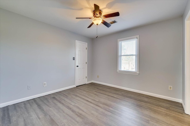 empty room with hardwood / wood-style flooring and ceiling fan