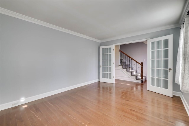 unfurnished room with french doors, ornamental molding, and light hardwood / wood-style flooring