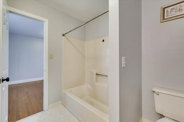 bathroom featuring toilet, shower / bath combination, and tile patterned flooring