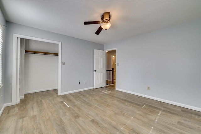 unfurnished bedroom featuring light hardwood / wood-style floors, a closet, and ceiling fan