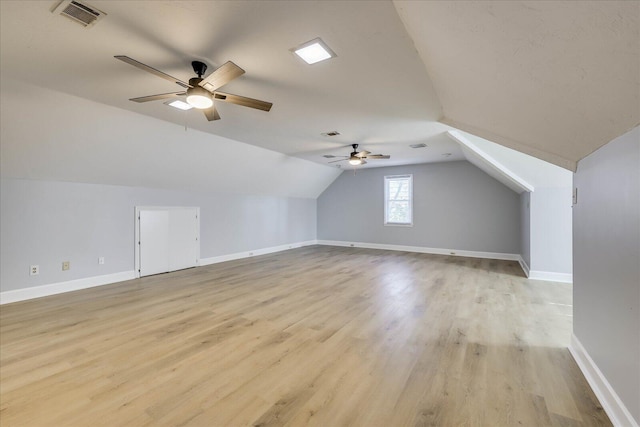 bonus room with ceiling fan, vaulted ceiling, and light hardwood / wood-style flooring