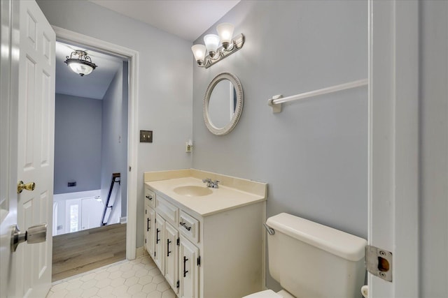 bathroom with vanity, toilet, and tile patterned flooring