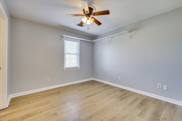 empty room with ceiling fan and light hardwood / wood-style floors