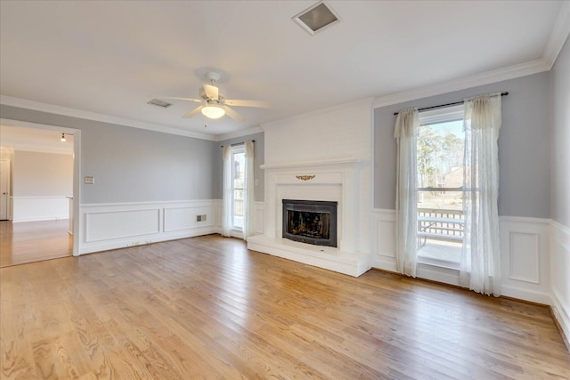 unfurnished living room featuring ornamental molding, light hardwood / wood-style floors, and ceiling fan