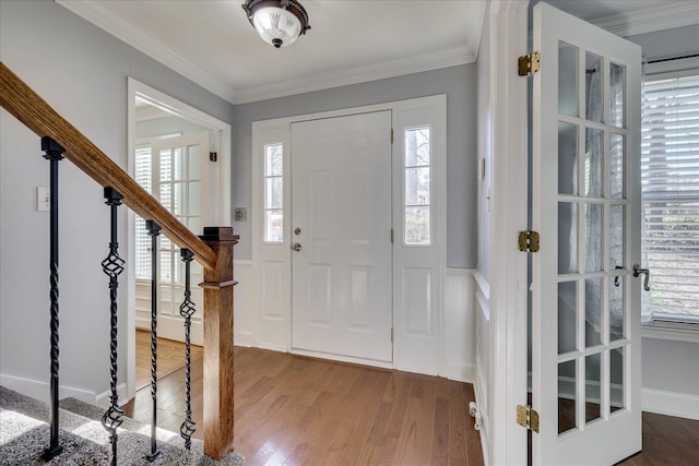 foyer with crown molding and wood-type flooring