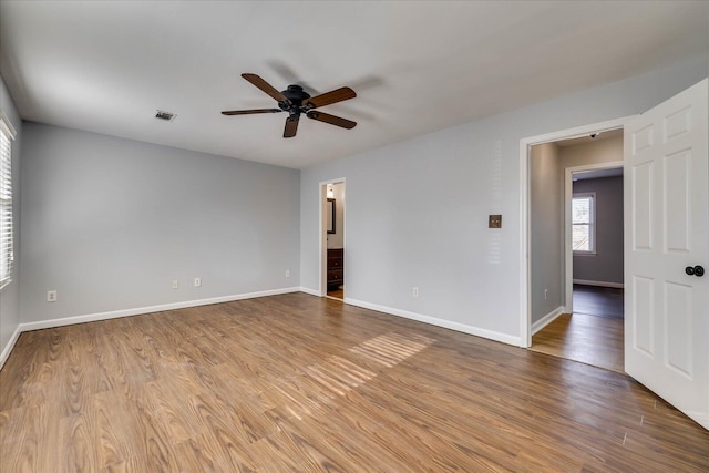 unfurnished room with ceiling fan and light wood-type flooring