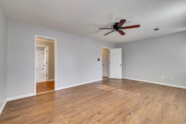 empty room with light hardwood / wood-style floors and ceiling fan