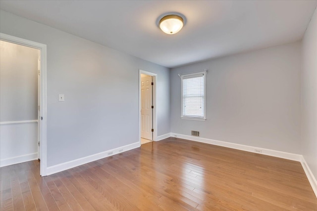 spare room with wood-type flooring