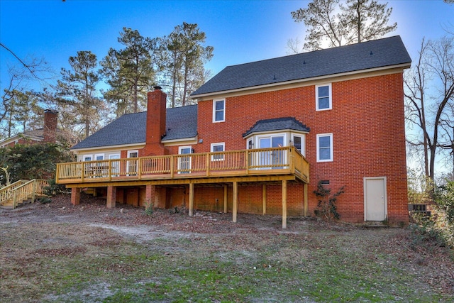 back of house featuring a wooden deck