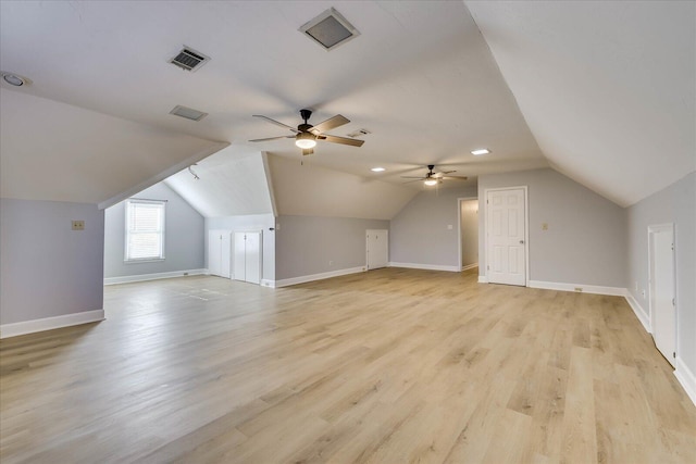 additional living space featuring ceiling fan, lofted ceiling, and light hardwood / wood-style flooring