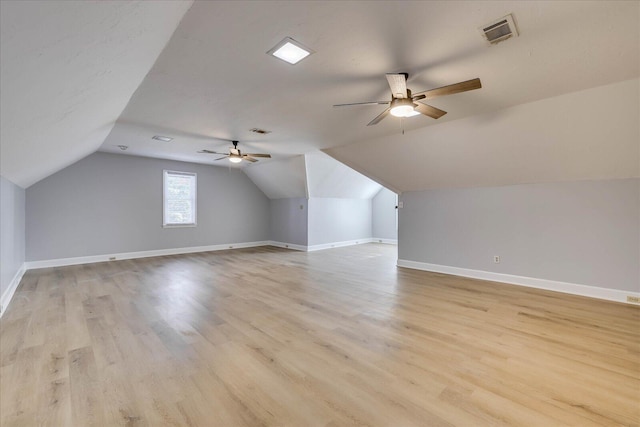 bonus room featuring vaulted ceiling, light hardwood / wood-style floors, and ceiling fan