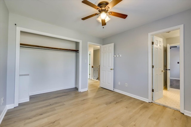 unfurnished bedroom with ceiling fan, light wood-type flooring, and a closet