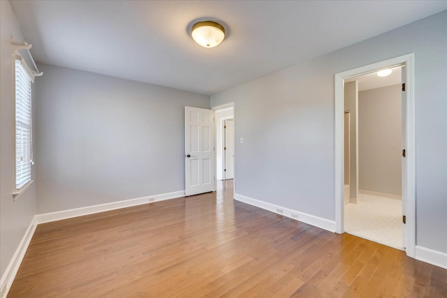 unfurnished bedroom with hardwood / wood-style flooring