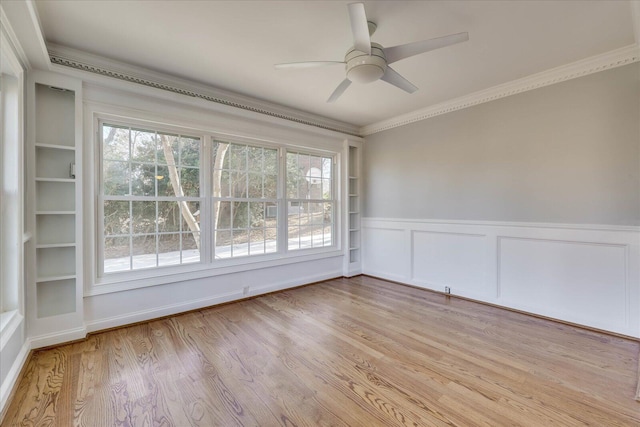 unfurnished room with ceiling fan, ornamental molding, a healthy amount of sunlight, and light wood-type flooring