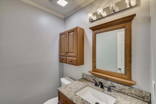 bathroom featuring vanity, ornamental molding, and toilet