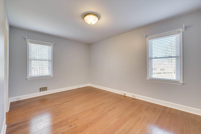 spare room with hardwood / wood-style floors