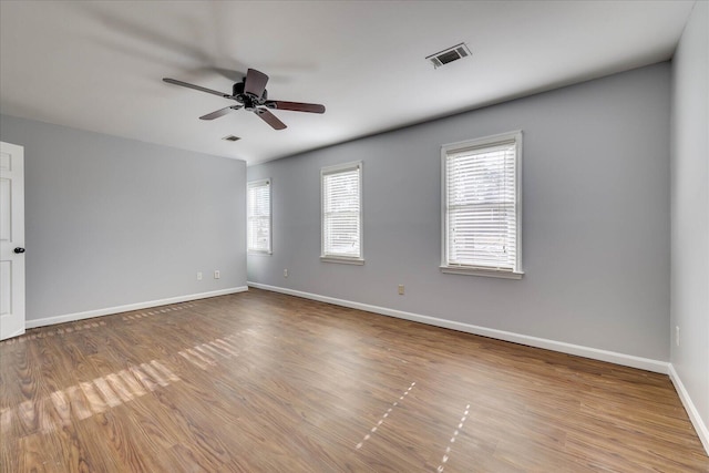 unfurnished room with hardwood / wood-style flooring and ceiling fan