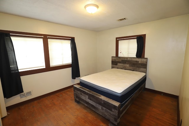 bedroom featuring dark wood-type flooring