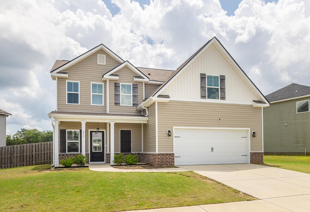 917 Linsmore Ave, Grovetown, GA 30813 - craftsman inspired home featuring a front yard, an attached garage, board and batten siding, fence, and driveway