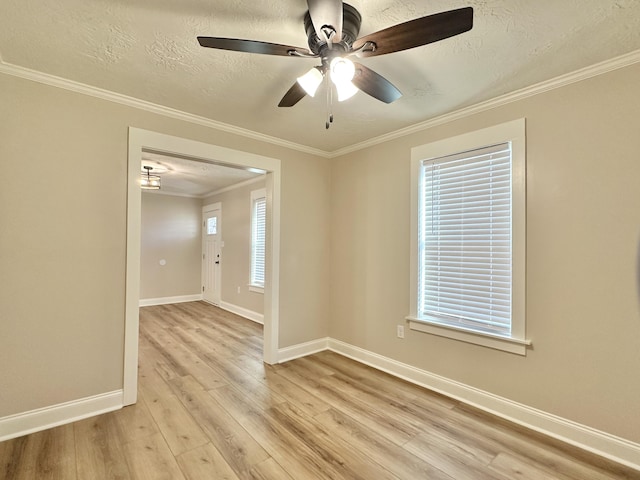 unfurnished room with light wood finished floors, crown molding, baseboards, ceiling fan, and a textured ceiling