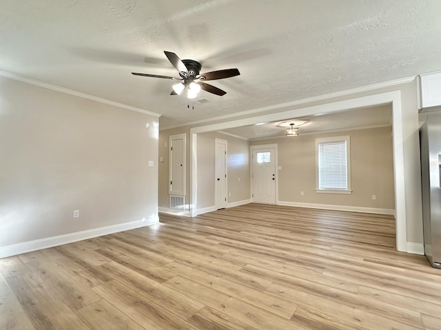 unfurnished living room featuring baseboards, visible vents, ceiling fan, light wood-style floors, and a textured ceiling