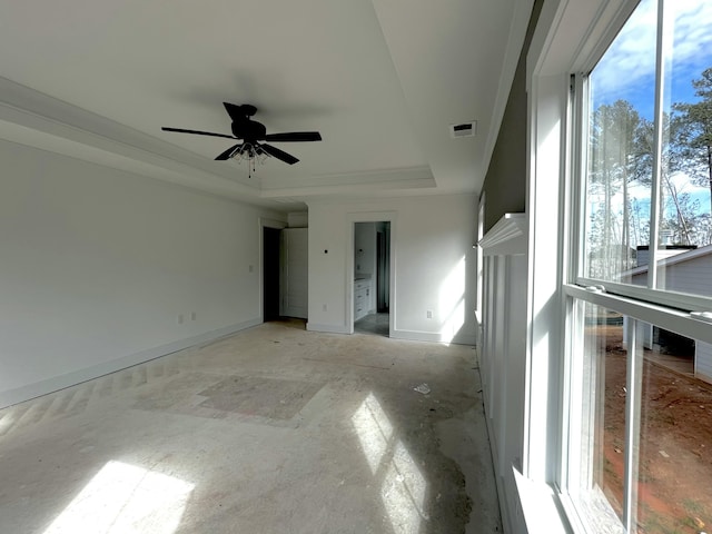 unfurnished room featuring ceiling fan, baseboards, visible vents, and a raised ceiling