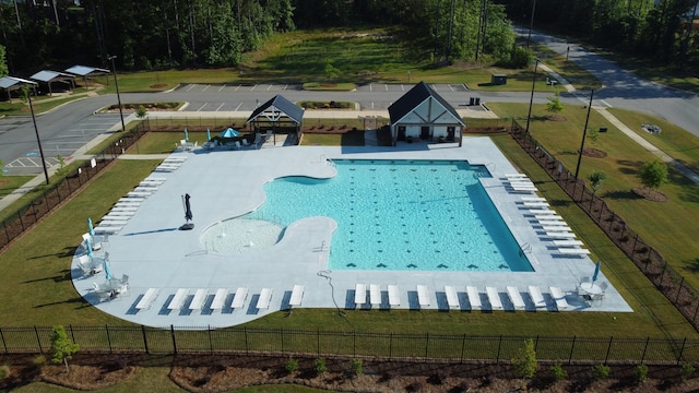 view of pool with a yard, fence, and a gazebo