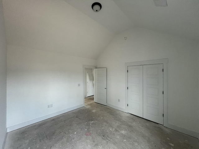 unfurnished bedroom featuring high vaulted ceiling and baseboards