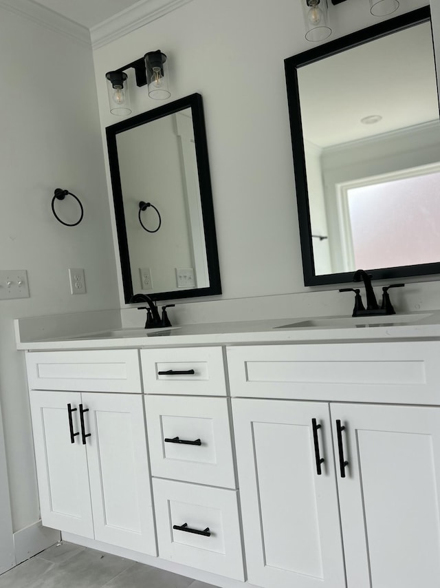 bathroom featuring double vanity, ornamental molding, and a sink