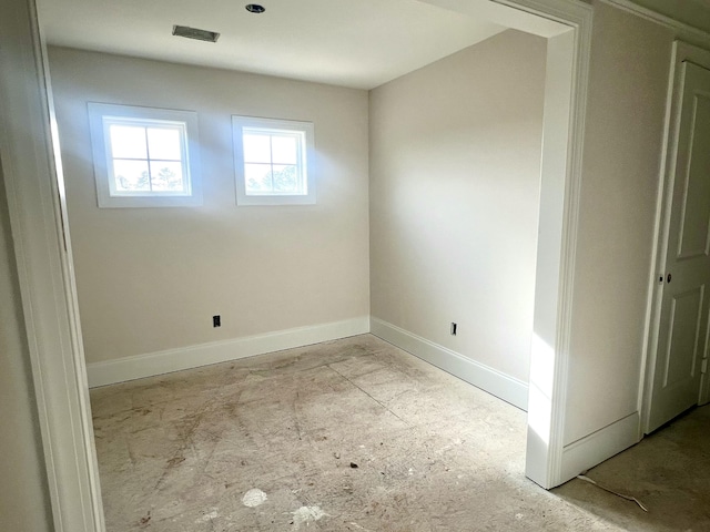 unfurnished room with visible vents and baseboards