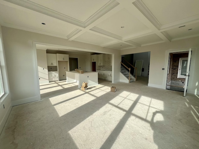 unfurnished living room featuring baseboards, stairway, coffered ceiling, and beam ceiling