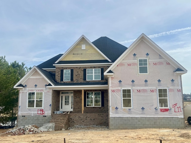 unfinished property featuring brick siding