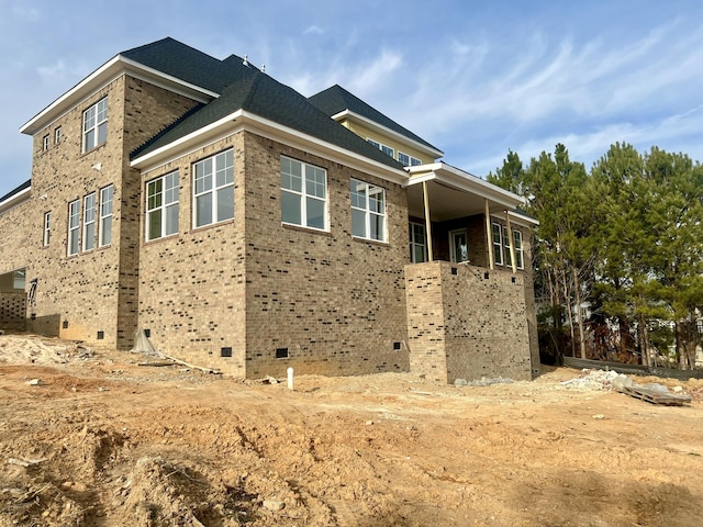 view of property exterior featuring brick siding and crawl space