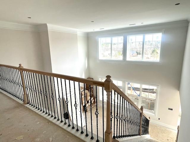 stairs featuring crown molding and baseboards