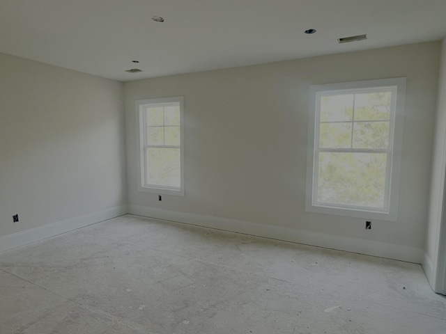 empty room featuring visible vents and baseboards