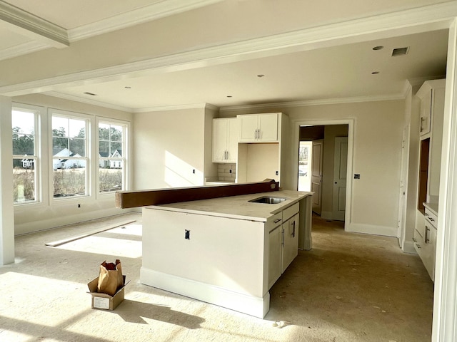 kitchen with crown molding, a center island, sink, and white cabinets