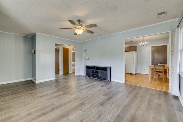 unfurnished living room with light wood finished floors, visible vents, a textured ceiling, crown molding, and ceiling fan with notable chandelier