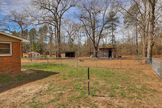 view of yard with fence and an outdoor structure