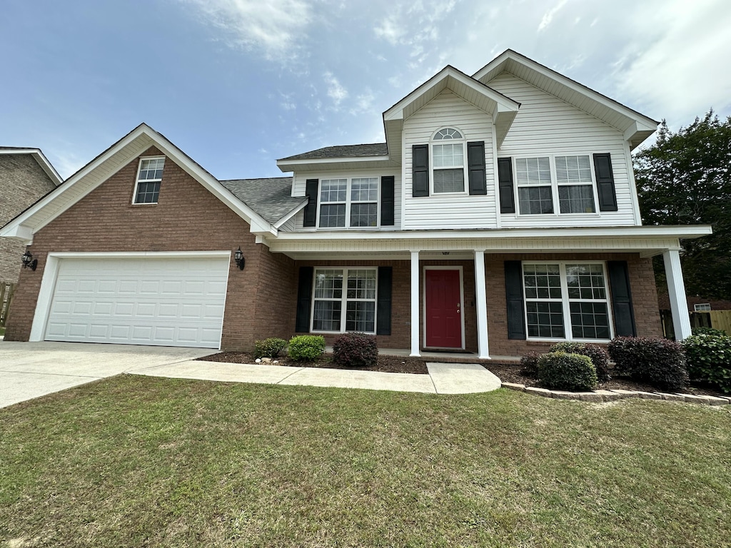 7623 Senators Ridge Dr, Grovetown, GA 30813 - view of front of home featuring brick siding, a garage, concrete driveway, and a front lawn