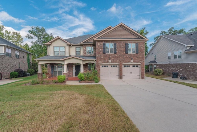 craftsman-style home with a front lawn, covered porch, and a garage