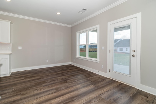 unfurnished dining area with dark hardwood / wood-style floors, crown molding, and a wealth of natural light