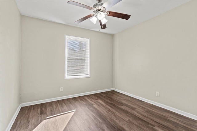 spare room featuring ceiling fan and dark wood-type flooring