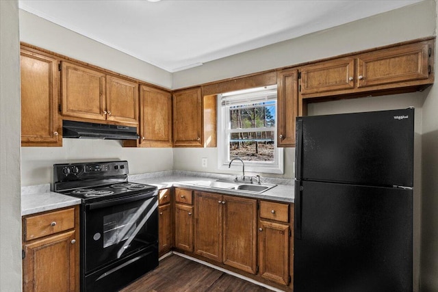 kitchen with black appliances, dark hardwood / wood-style flooring, and sink