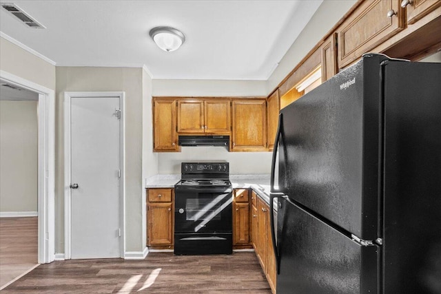 kitchen with dark wood-type flooring and black appliances