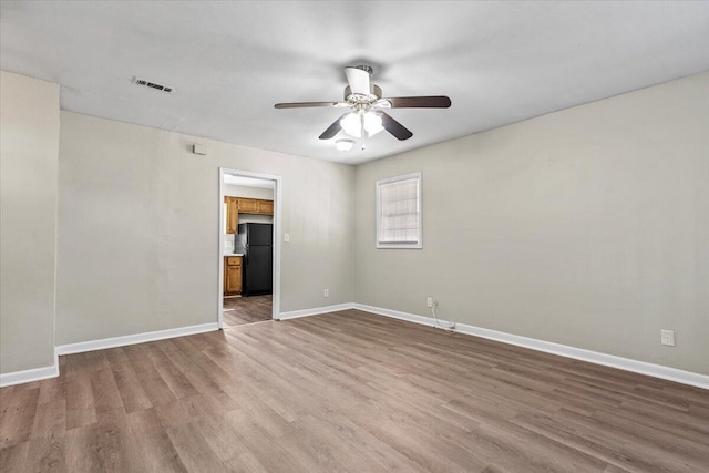 unfurnished room with ceiling fan and hardwood / wood-style flooring