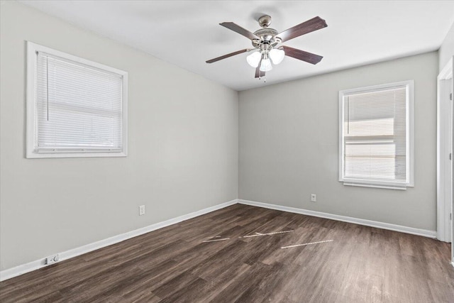 spare room featuring ceiling fan and dark hardwood / wood-style floors