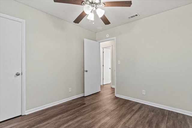 interior space with ceiling fan and dark wood-type flooring